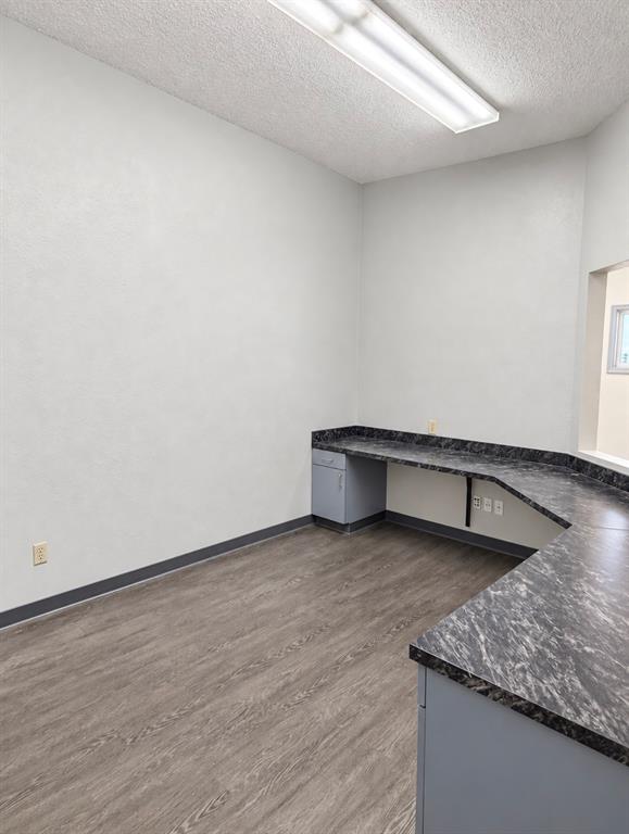 Reception office with a wrap-around laminate desk and pass-through window